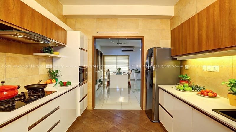 Parallel modular kitchen in wood and white with cooktop, chimney and fresh fruit on the counter, Hyderabad