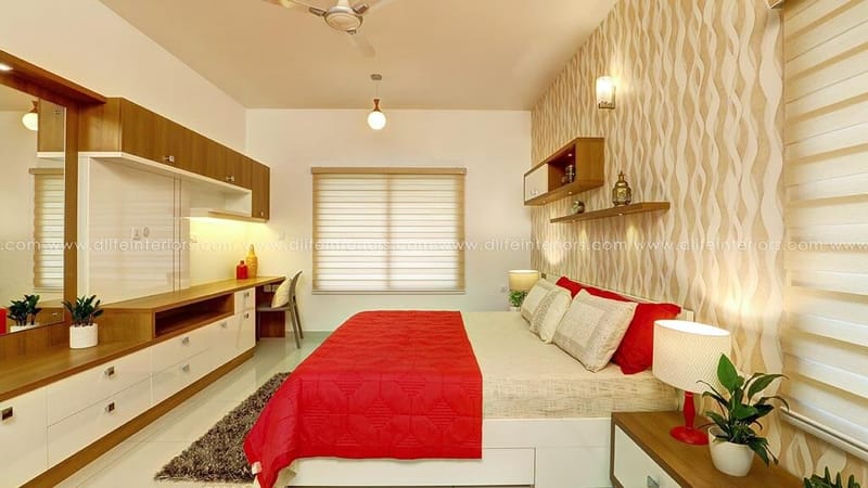 Master bedroom with red bed, wavy feature wallpaper, mirrored dresser unit and study counter, Hyderabad