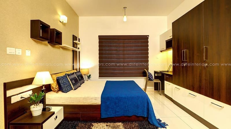 Bedroom with dark-wood wardrobe, blue bedspread, floating wall cubes and timber window blinds, Hyderabad