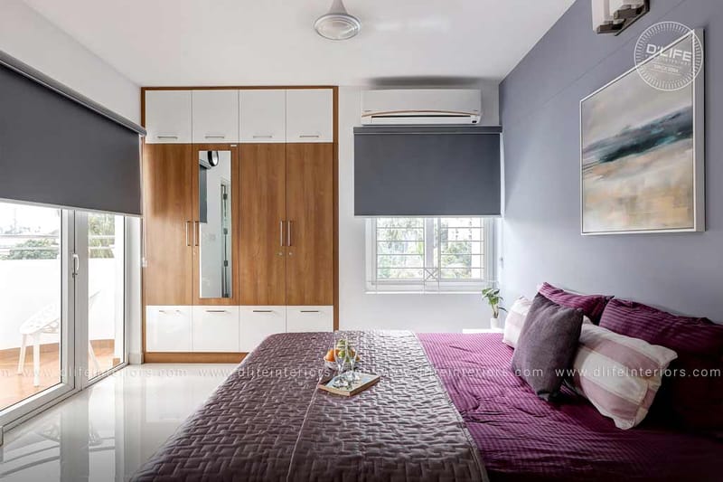 Blue-grey bedroom with grey velvet bedding, floral framed art, fresh gerberas and a tea tray, Hyderabad