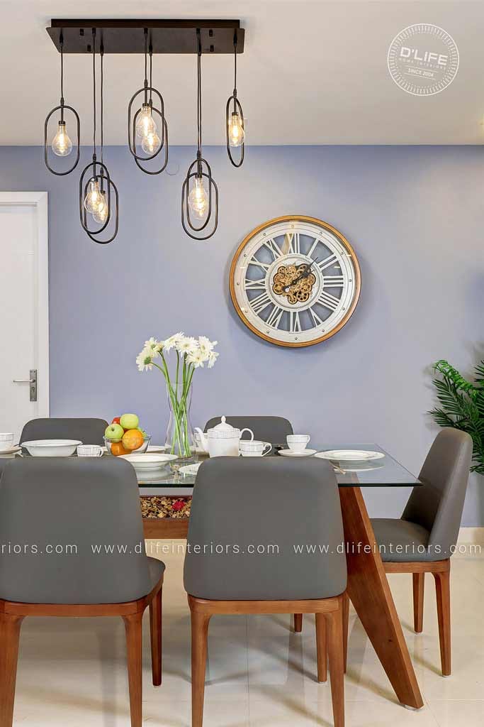 Dining room with lavender accent wall, glass-top wood table, grey leather chairs and a black wire pendant cluster, Hyderabad
