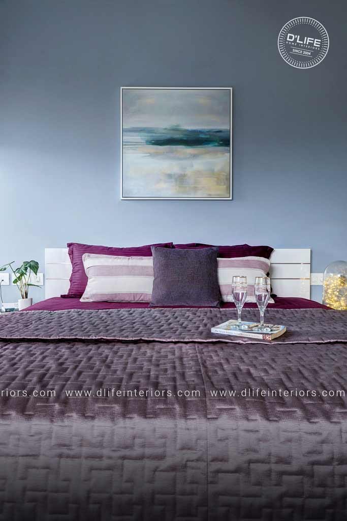 Grey-toned bedroom with white slatted headboard, plum quilted bedding and a framed abstract seascape above, Hyderabad