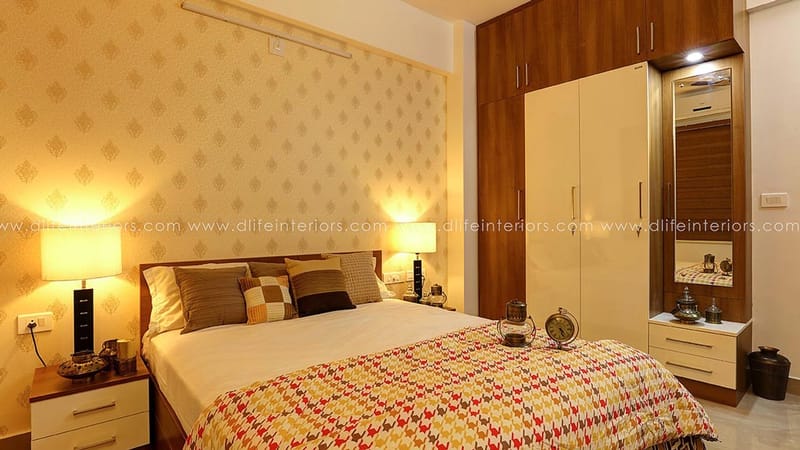 Master bedroom with upholstered headboard, glossy two-tone wardrobe, twin table lamps and subtle patterned wallpaper, Hyderabad
