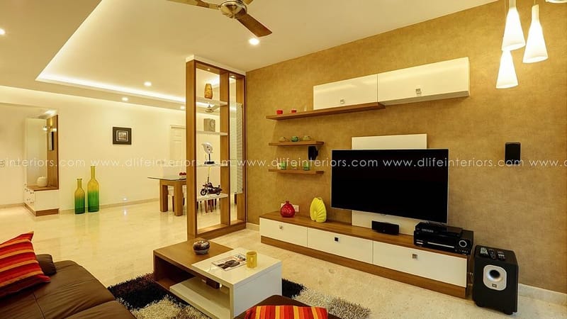 Living room with floating TV unit, glass display partition and beige textured feature wall, Hyderabad full-home project