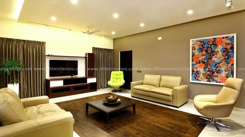 Living room with beige leather sofas, lime-green ottoman, wood coffee table and a large abstract painting, Hyderabad