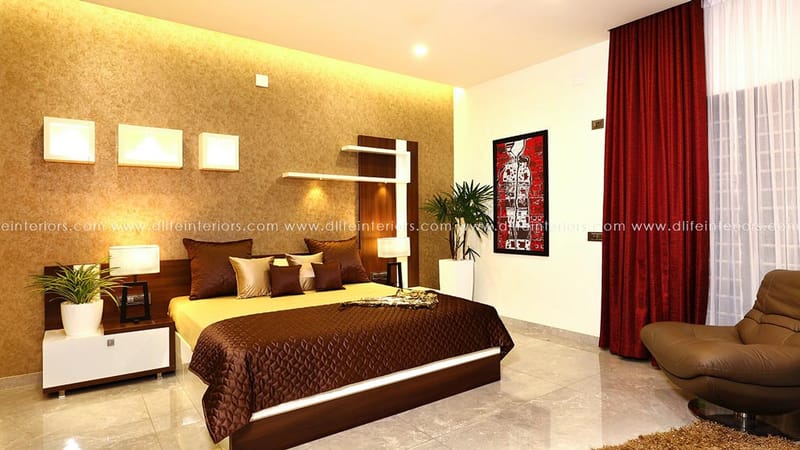 Bedroom featuring gold textured accent wall, brown quilted bed, floating shelves and red curtains, Hyderabad