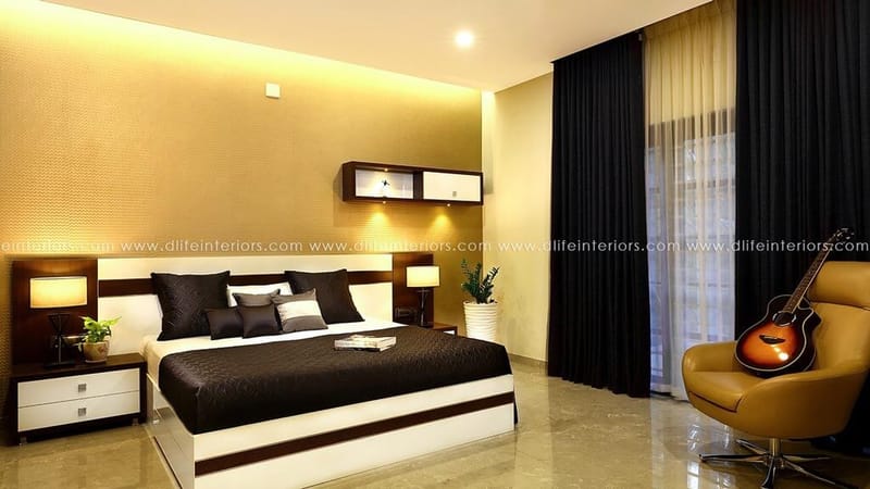 Bedroom with gold wall, white bed dressed in black, black drapes and a mustard leather chair with a guitar, Hyderabad