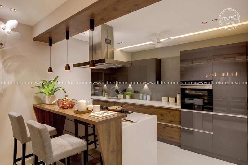 Modular kitchen in Hyderabad with glossy grey cabinets, wood-grain island, breakfast bar and built-in chimney