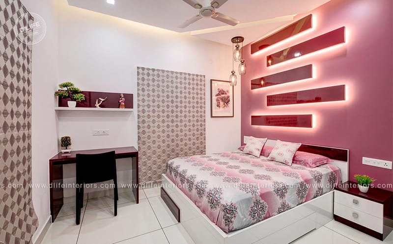 Pink-accent bedroom with backlit display shelves, patterned wall panels and a compact study desk, Hyderabad home
