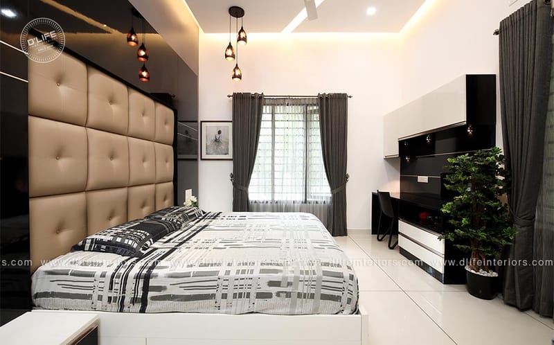 Bedroom with tan tufted leather headboard, black wall-mounted TV unit, grey blackout curtains and a study desk, Hyderabad