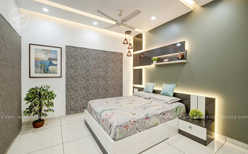Bright bedroom with floral bedspread, framed abstract art, backlit grey headboard niche and potted ficus, Hyderabad