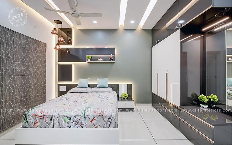 Modern bedroom with glossy grey sliding wardrobes, floral bedspread, cove-lit niches and copper pendant lights, Hyderabad
