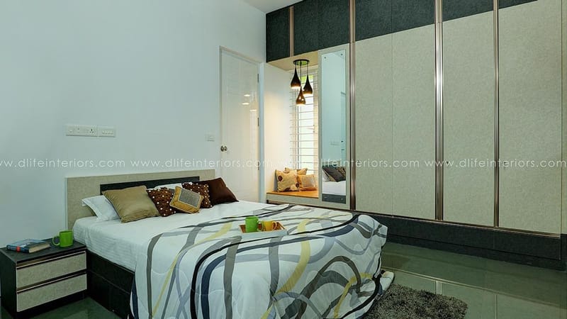 Bedroom with textured grey sliding wardrobe, patterned bedspread, pendant lights and mirrored niche, Hyderabad