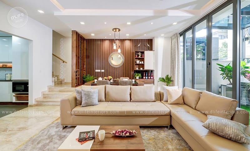 Open-plan living room with L-shaped beige sofa, fluted wood feature wall and pendant light, Hyderabad full home