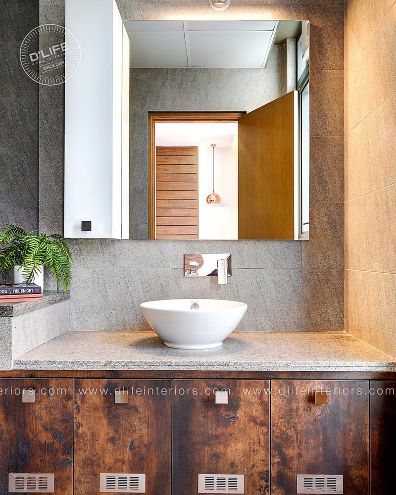 Bathroom vanity clad in grey stone with a white vessel basin, large mirror and rustic timber base cabinet
