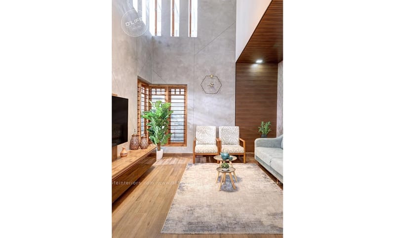 Double-height living room with wood-slat ceiling, plank flooring, twin armchairs and grey textured walls, Hyderabad