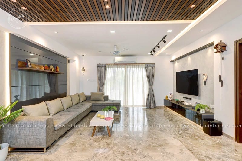 Modern living room with wood-slat ceiling, grey L-shaped sofa and marble floor, Hyderabad full home interior