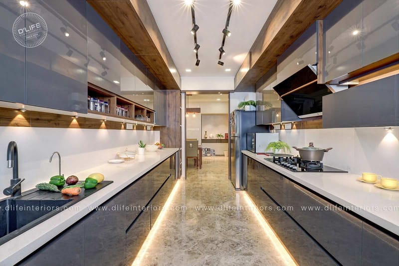 Parallel modular kitchen in glossy grey and white with quartz counters, LED toe-kick lighting and chimney, Hyderabad full home