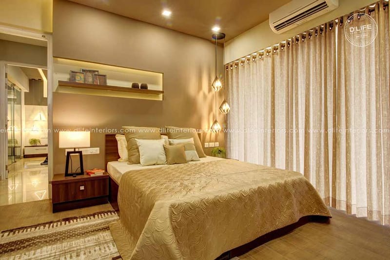 Warm-toned master bedroom with upholstered bed, gold quilt, pendant cluster lights and sheer curtains, Hyderabad