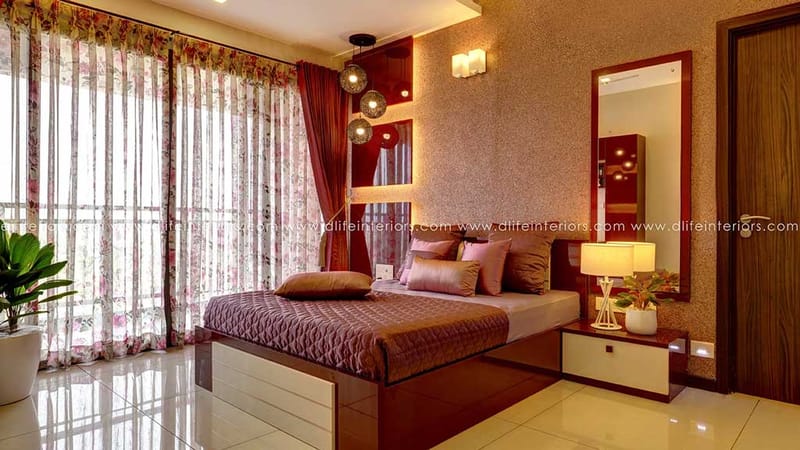 Bedroom with floor-to-ceiling floral sheers, textured wall, brown bedding, glass pendants and mirror, Hyderabad