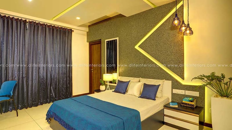 Bedroom with textured grey feature wall, LED chevron cove, navy bedding and glass pendant lights, Hyderabad