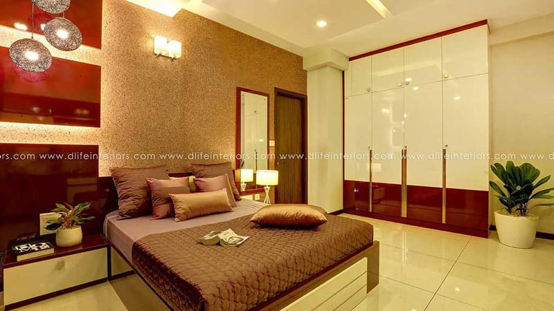 Bedroom with gold textured accent wall, high-gloss sliding wardrobe, brown bedding and cluster pendant lights, Hyderabad