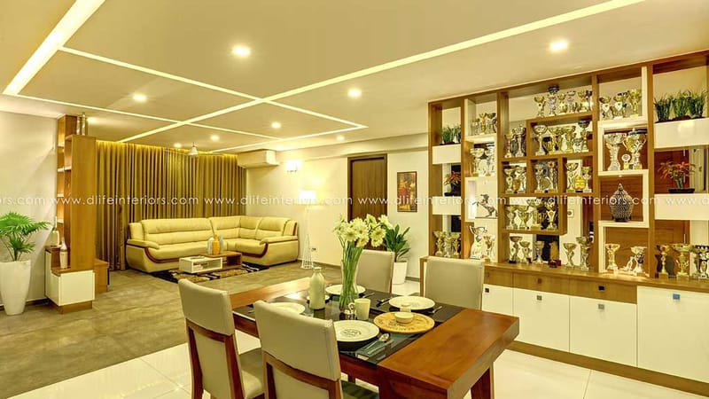 Open living and dining hall with trophy display shelving, beige leather sofa and recessed false-ceiling lighting, Hyderabad