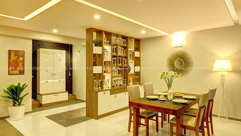 Dining area in Hyderabad with wood-and-white crockery display partition, six-seat table, sunburst mirror and floor lamp