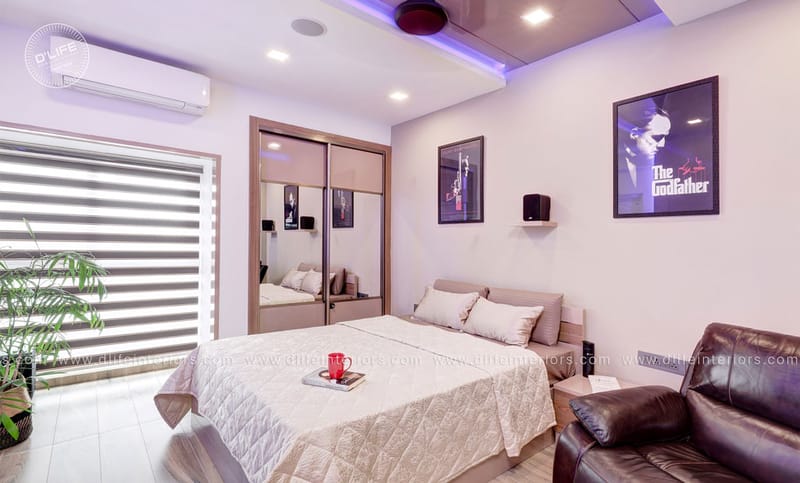 Bedroom with mirrored sliding wardrobe, The Godfather poster, cove lighting and a leather armchair, Hyderabad