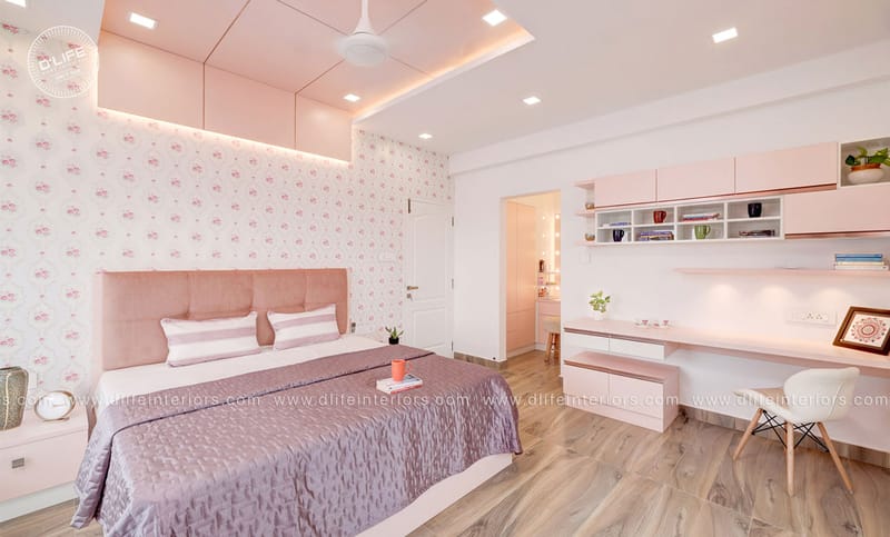 Pink-themed girls bedroom with floral wallpaper, blush headboard, fitted study desk and wooden flooring, Hyderabad home