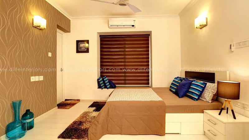 Bedroom with low platform bed, wooden roller blinds, twin wall sconces and striped accent pillows in warm tones, Hyderabad