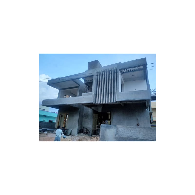 Bare grey concrete two-storey house under construction, exposed RCC frame and cantilevered balconies at the site, Hyderabad