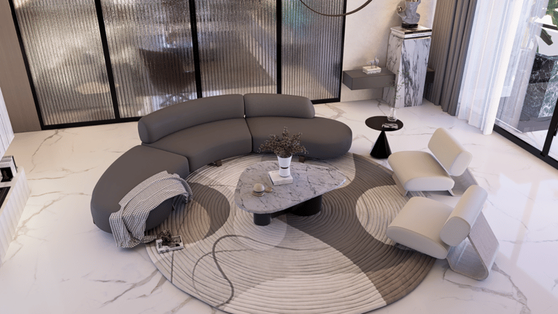Living room overhead view with curved grey sofa, round marble coffee table and layered circular rug, Hyderabad