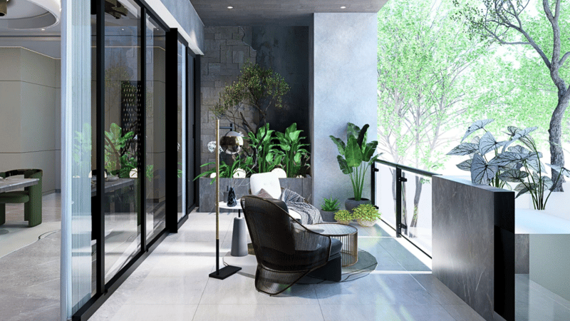 Balcony retreat in Hyderabad with leather lounge chair, layered planters, stone-clad wall and glass railing beside sliding doors