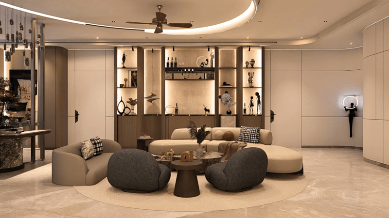 Open-plan living lounge with curved sofas on a round rug, sculptural shelving and decor objects in a warm neutral palette, Hyderabad