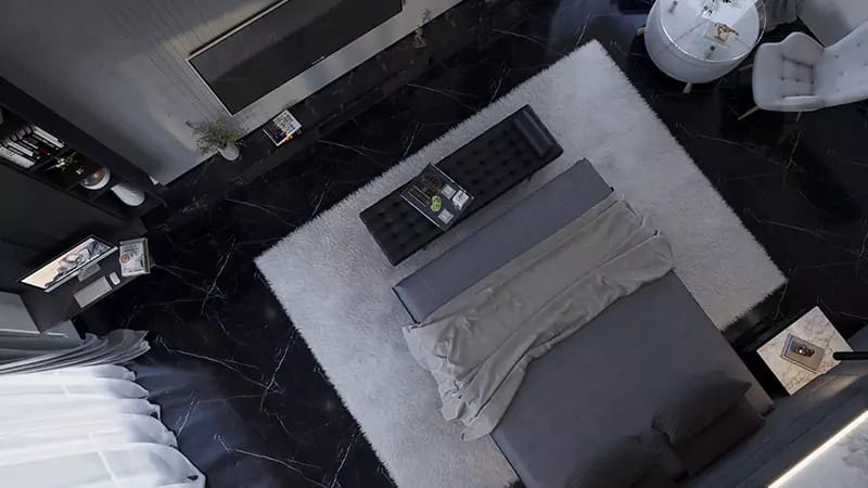 Overhead view of a bedroom on black marble flooring with grey bed, tufted bench and pale area rug, Hyderabad