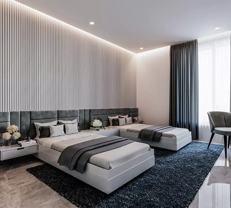 Twin-bed guest room with fluted wall panelling, charcoal tufted headboards, navy shag rug and grey throws, Hyderabad