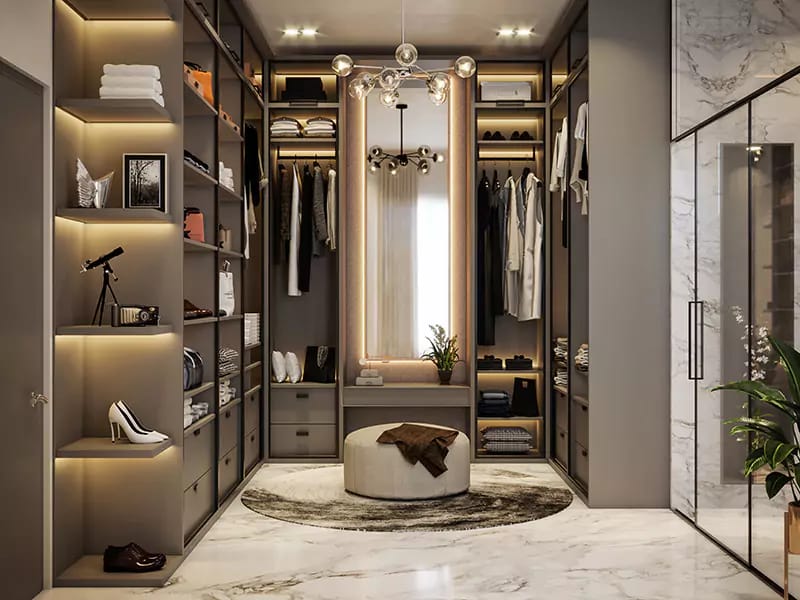 Walk-in wardrobe with backlit open shelving, central island seat, sputnik chandelier and marble floor in Hyderabad