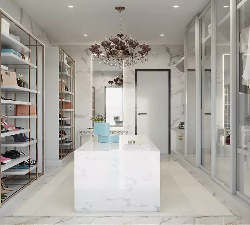 White marble walk-in closet with glass shelving, mirrored island, crystal chandelier and shoe display, Hyderabad
