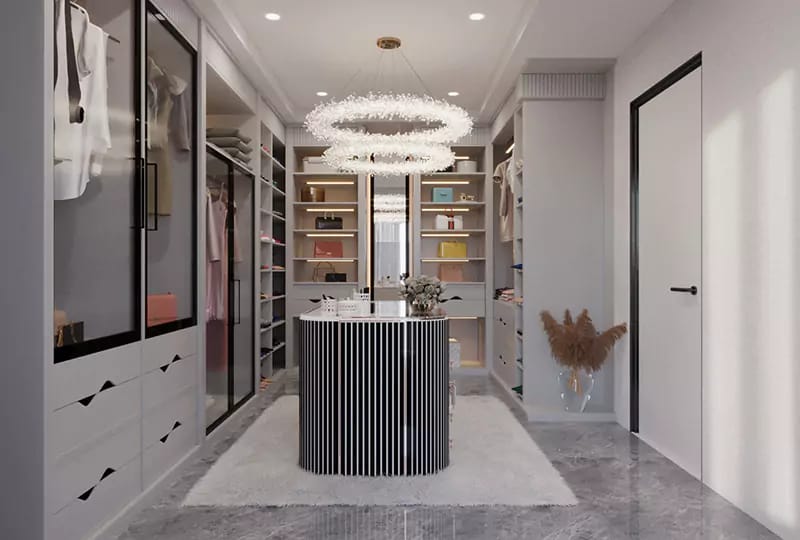 Walk-in wardrobe with glass-front cabinetry, fluted island, ring crystal chandelier and grey marble floor, Hyderabad