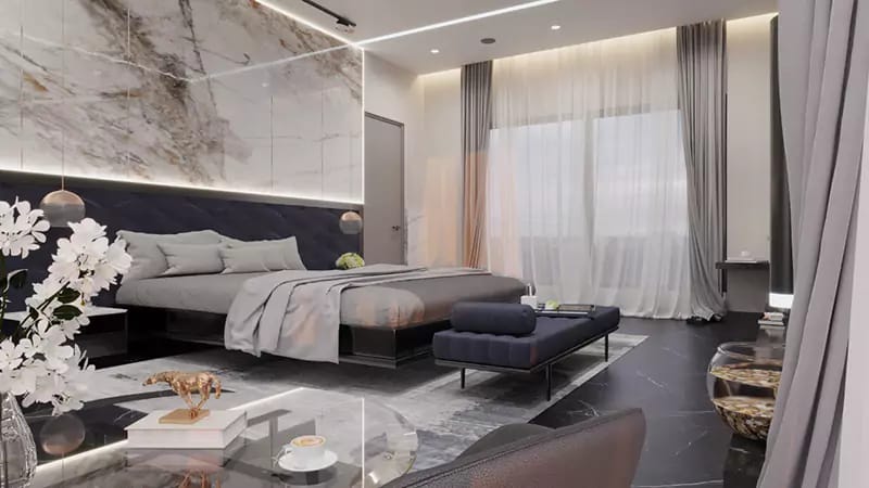 Luxe master bedroom with veined marble headboard wall, navy bench, sheer drapes and orchid styling, Hyderabad
