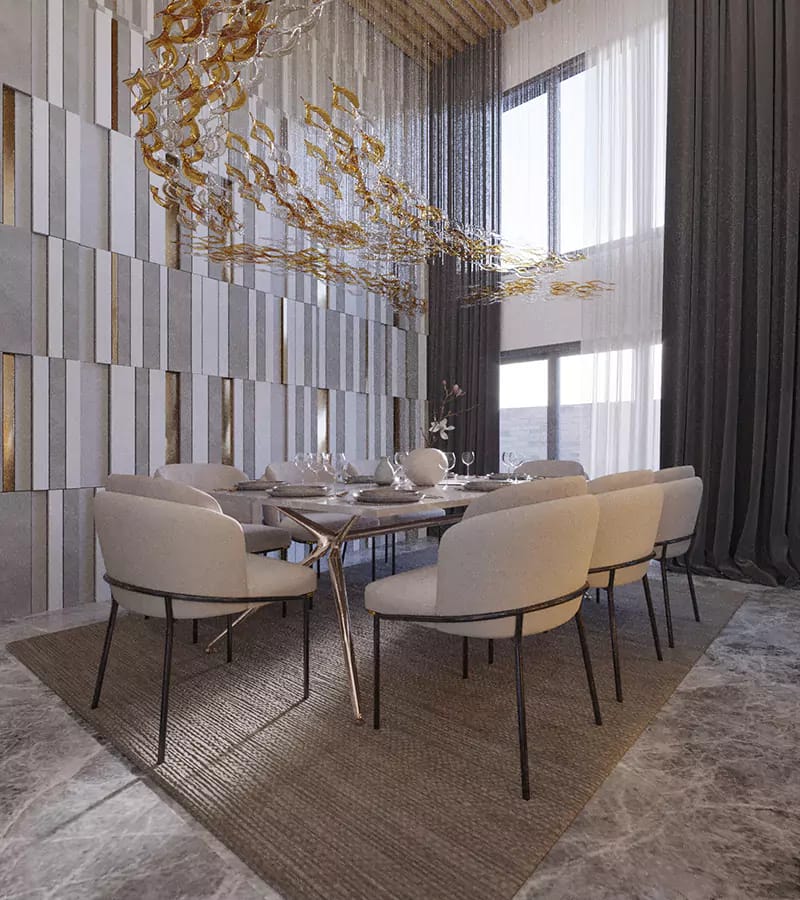 Double-height dining room with gold leaf-cluster chandelier, cream upholstered chairs and mosaic stone accent wall, Hyderabad