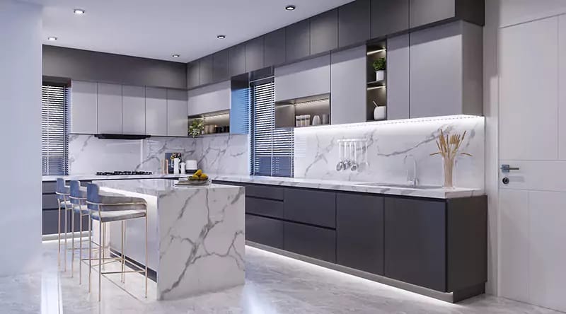 Modern kitchen with waterfall marble island, blue bar stools, two-tone grey cabinets and Calacatta backsplash, Hyderabad