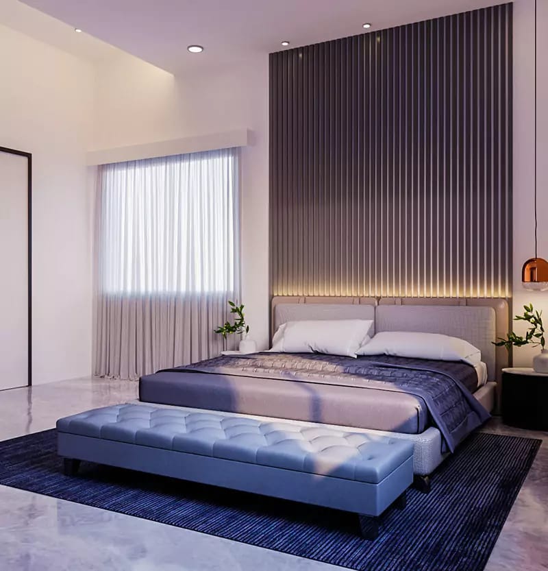 Bedroom with vertical fluted accent wall, backlit headboard, low blue tufted bench and navy rug, Hyderabad