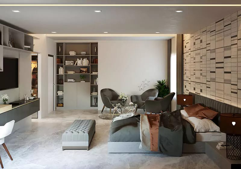 Bedroom-lounge in Hyderabad with grey upholstered bed, built-in shelving, tufted bench and accent armchairs by a TV unit