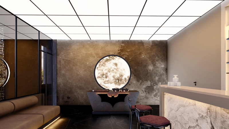 Reception lounge with backlit moon-motif feature wall, marble desk, bench seat and gridded ceiling, Hyderabad