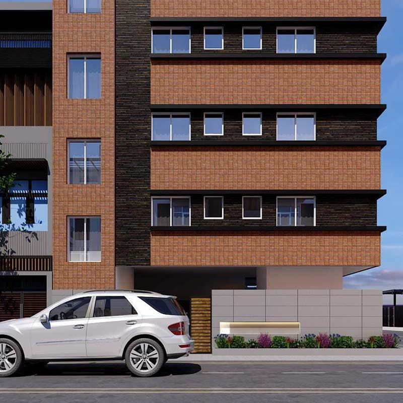 Side-angle render of a brick-clad apartment building with dark accent panel and street parking in Hyderabad