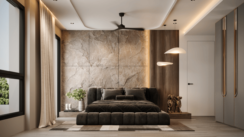 Bedroom featuring a tufted low bed against a beige marble accent wall with warm wood paneling and a soft pendant lamp
