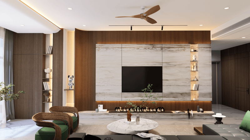 Spacious living room with wood-and-marble TV feature wall, slim ceiling fan and green accent sofa, Hyderabad