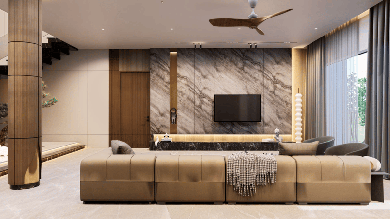 Living room TV wall in book-matched marble with wall-mounted screen and tufted beige sectional, Hyderabad home